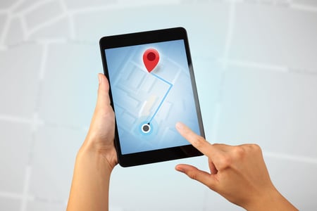 Female fingers touching tablet with map-1